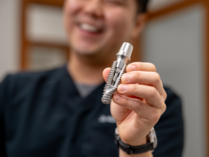Dr. Kelvin holding implant